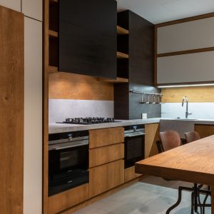 Stylish contemporary kitchen featuring wooden accents and modern appliances.